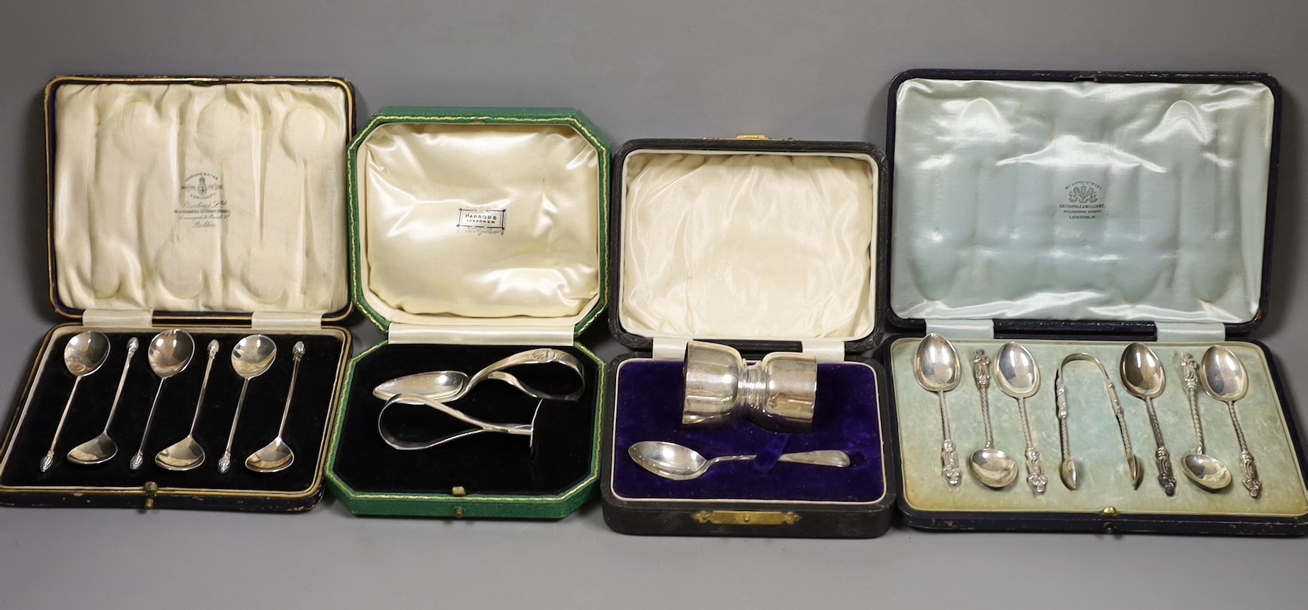 Two cased silver Christening sets, egg cup and spoon and pusher and spoon, a cased set of acanthus terminal coffee spoons, and a cased set of six apostle teaspoons and tongs, 7oz.